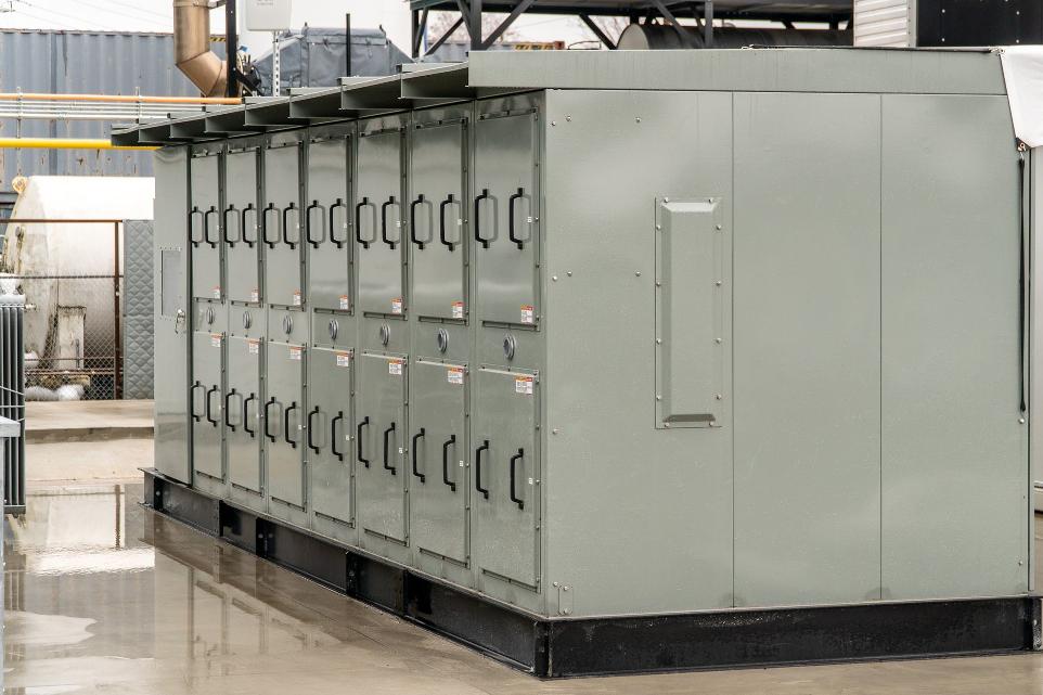 backside view of outdoor rated switchgear lineup installed on a concrete pad