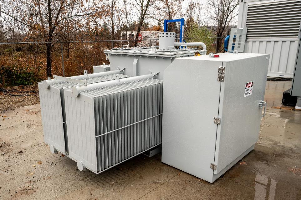 grey transformer on a concrete pad outdoors