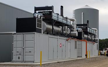 two containerized cHP generators installed next to a greenhouse building