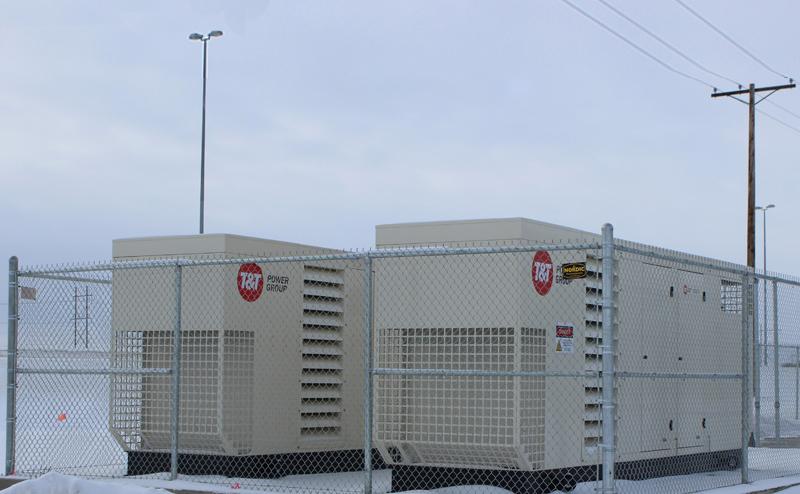 two enclosed diesel generators outside a municipal building