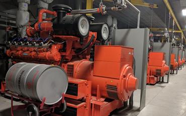 Several 500kW prime power generators inside a generator building.