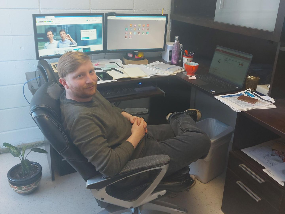 Photo of Bradley working at his desk